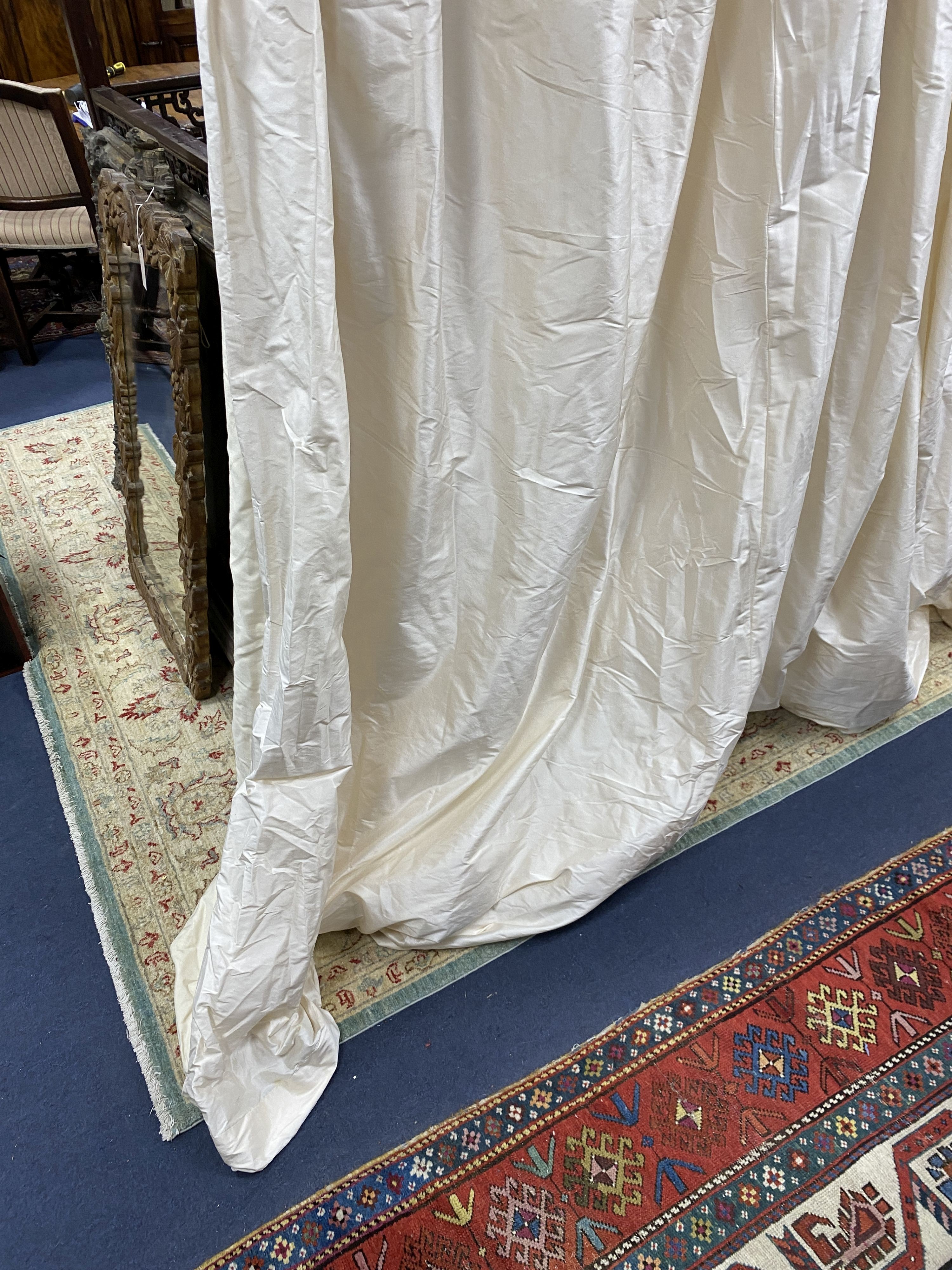 A large pair of cream silk curtains. 100 inches drop